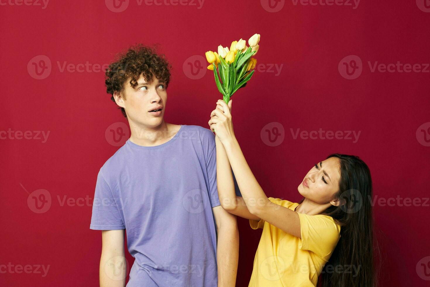 joven chico y niña regalo ramo de flores de flores divertido rojo antecedentes inalterado foto