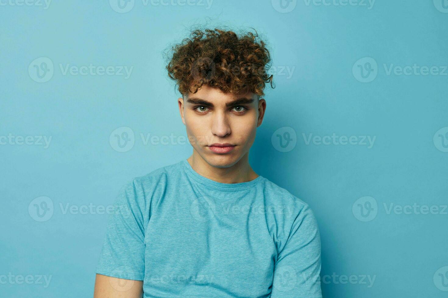 handsome guy in blue t-shirts with a pumped-up body isolated background photo