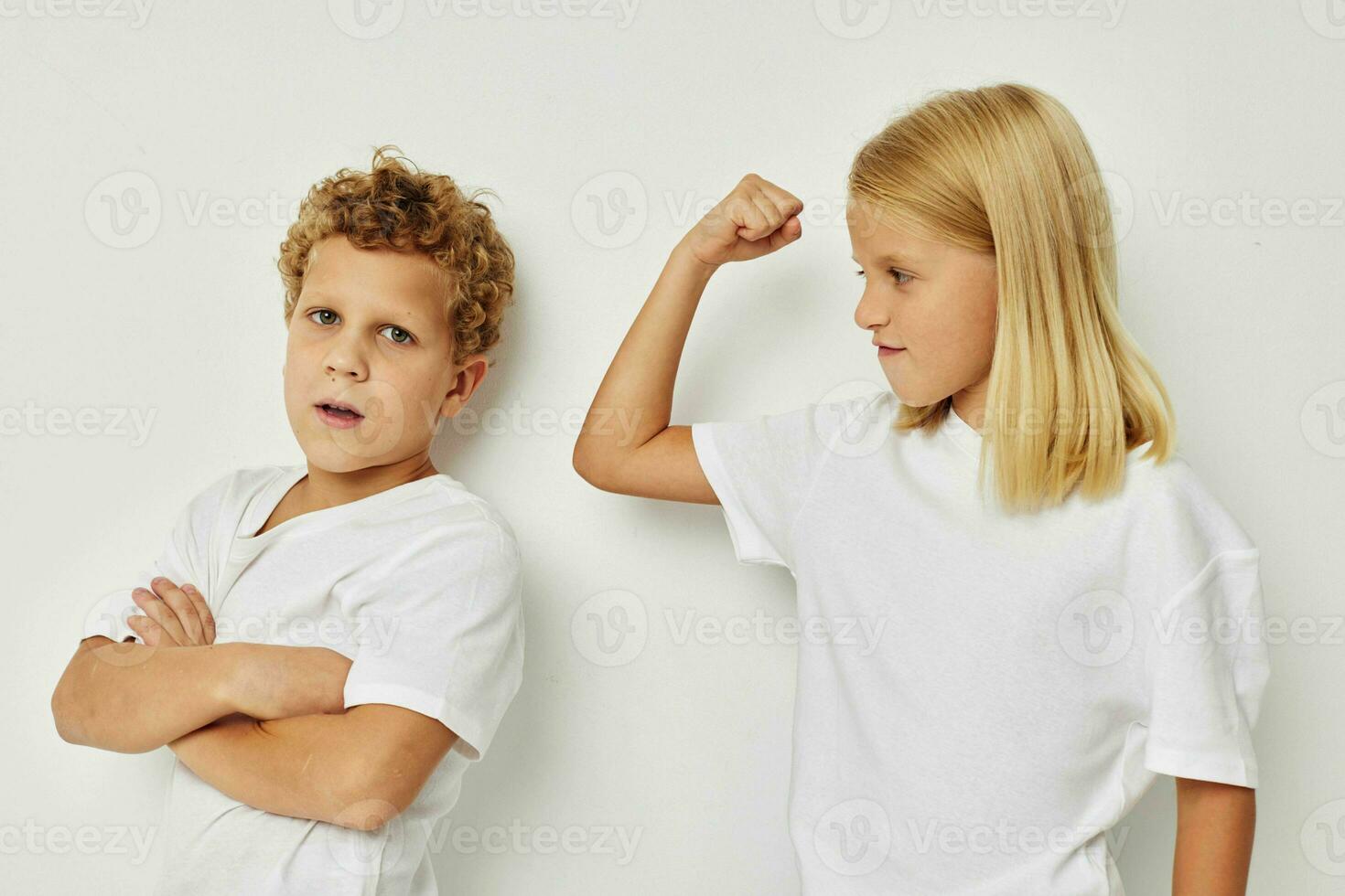 Cute stylish children in white T-shirts are standing next to Lifestyle unaltered photo