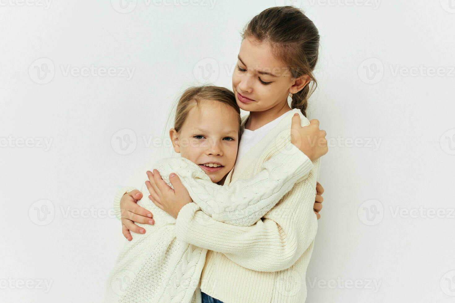 two little girls girlfriends posing light background photo