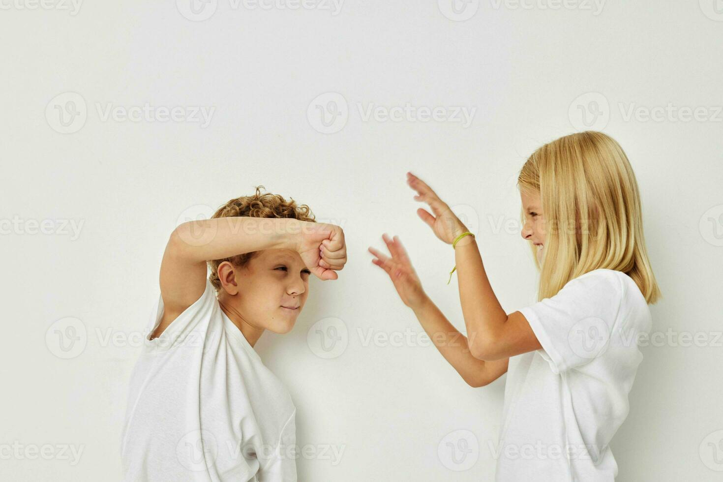 Cute stylish children in white T-shirts are standing next to Lifestyle unaltered photo