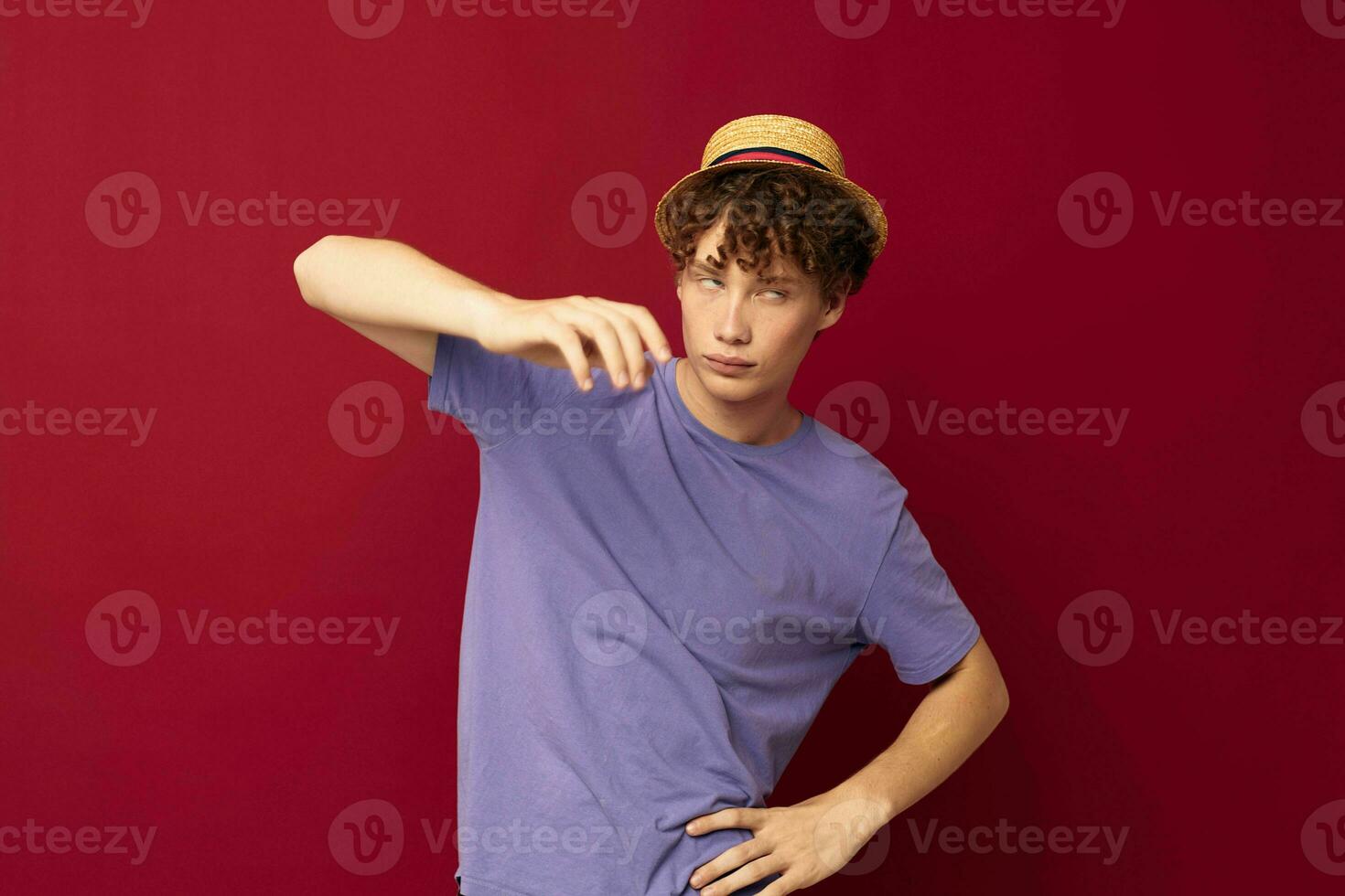 young guy red hair in casual wear Youth Style Studio red background unaltered photo