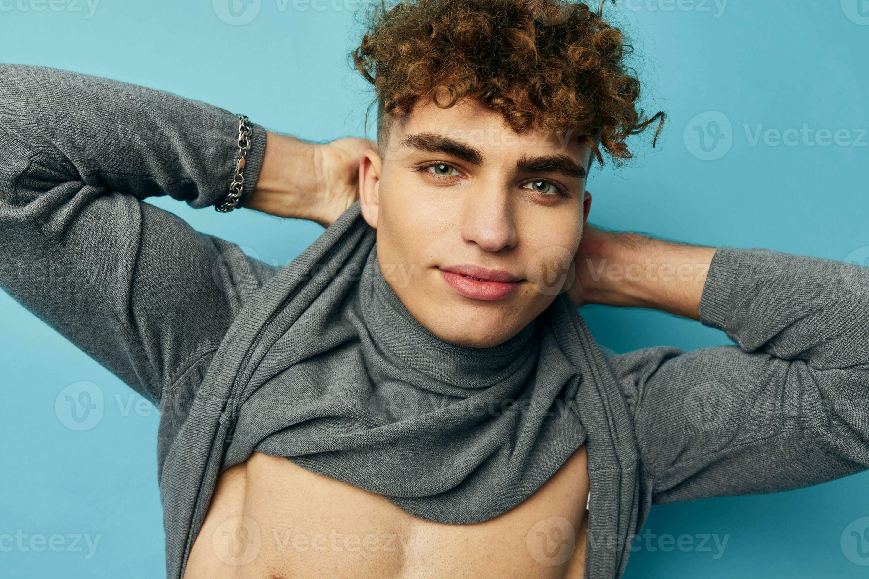 cute guy with curly hair posing blue background 25707524 Stock Photo at