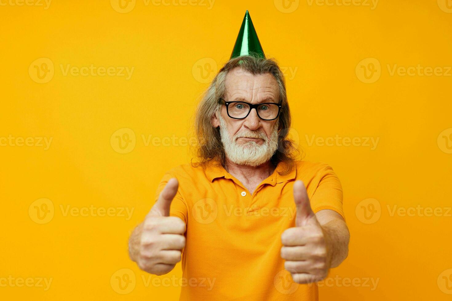 Senior grey-haired man wearing glasses green cap on his head holiday emotions monochrome shot photo