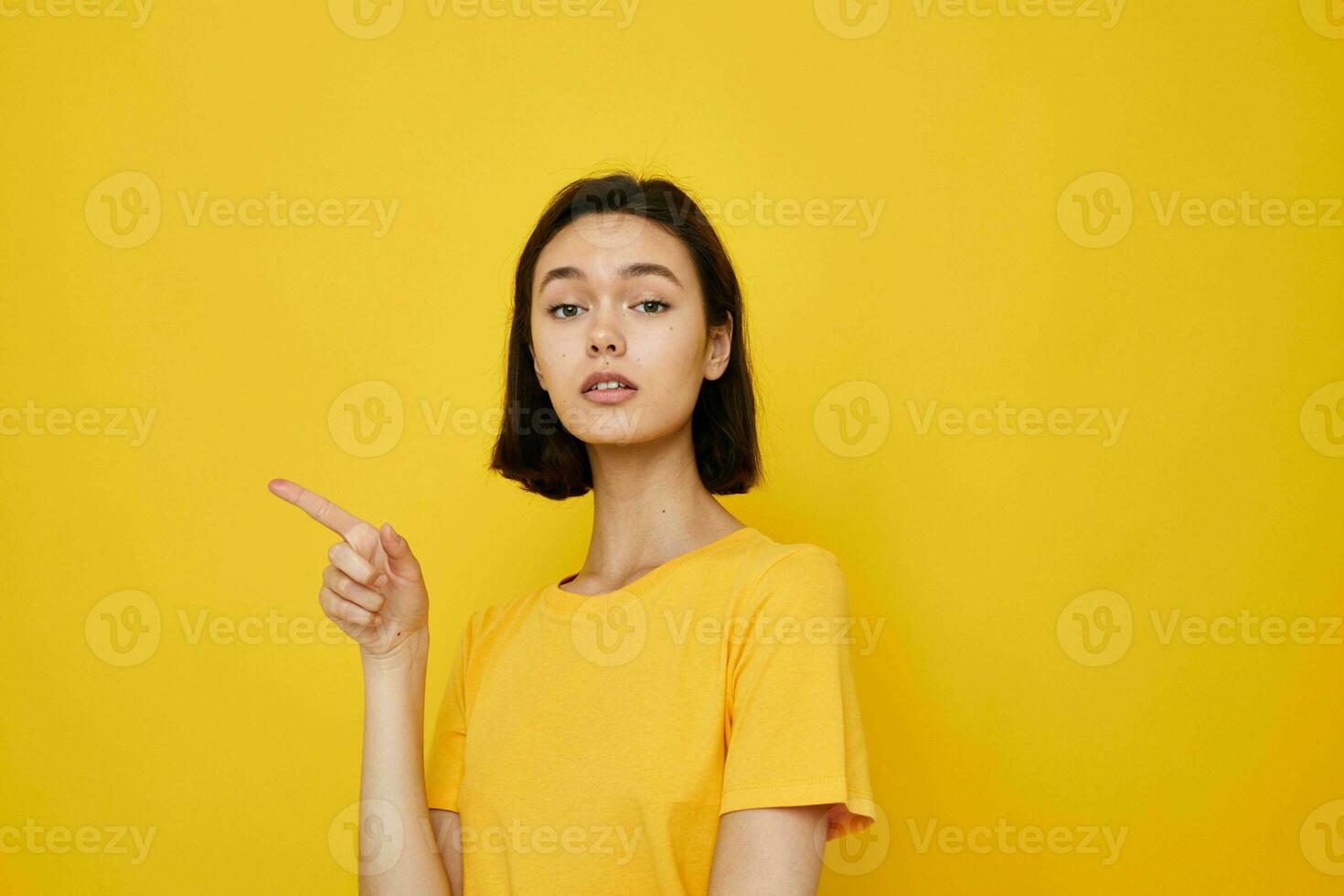 short haired brunette in a yellow t-shirt Youth style casual isolated background photo