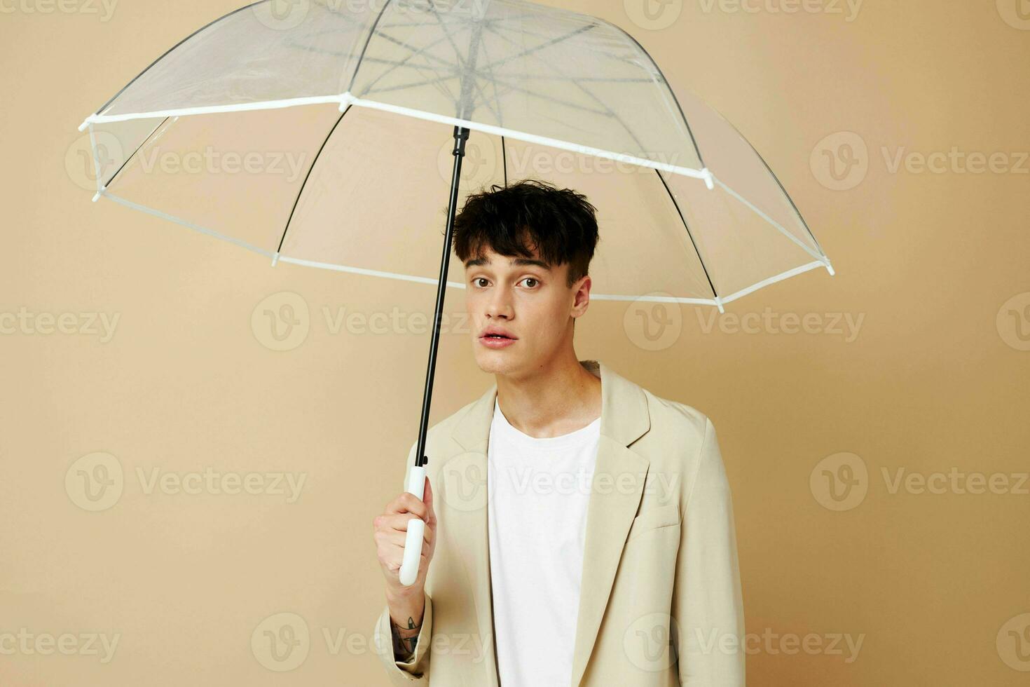 nice guy in a jacket with an open umbrella protection from the rain photo