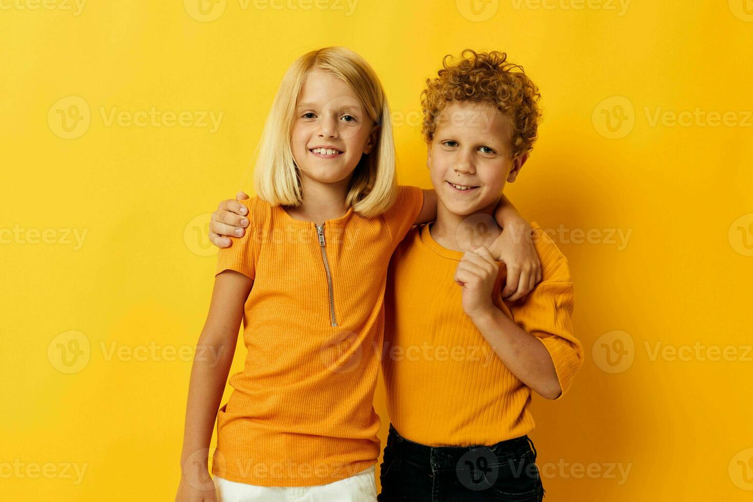 Cute preschool kids casual wear games fun together posing on colored background photo