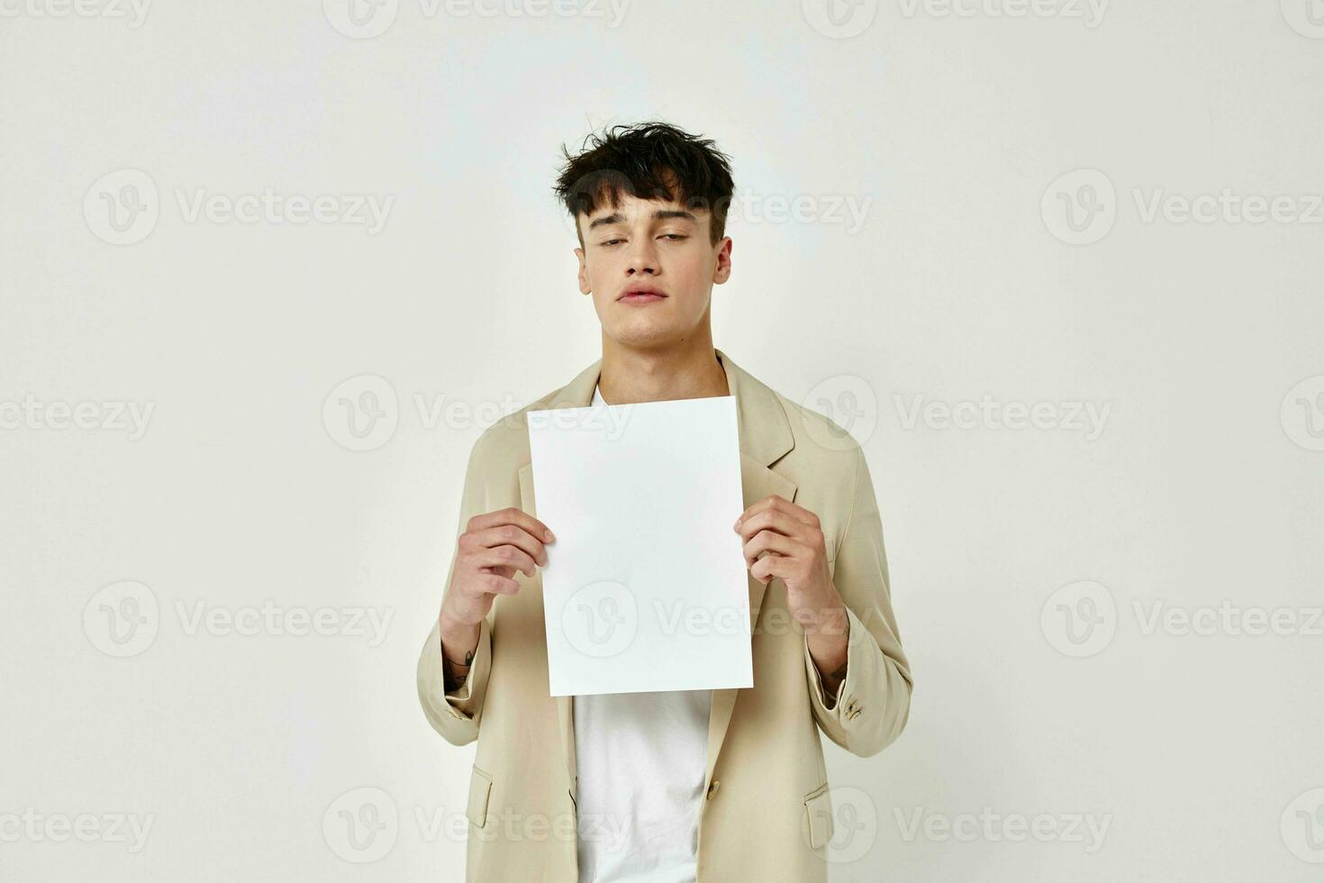 Man posing with a white sheet of paper light background unaltered photo