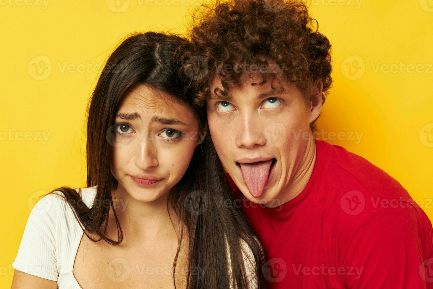 portrait of a man and a woman Friendship posing hugs together yellow background unaltered photo