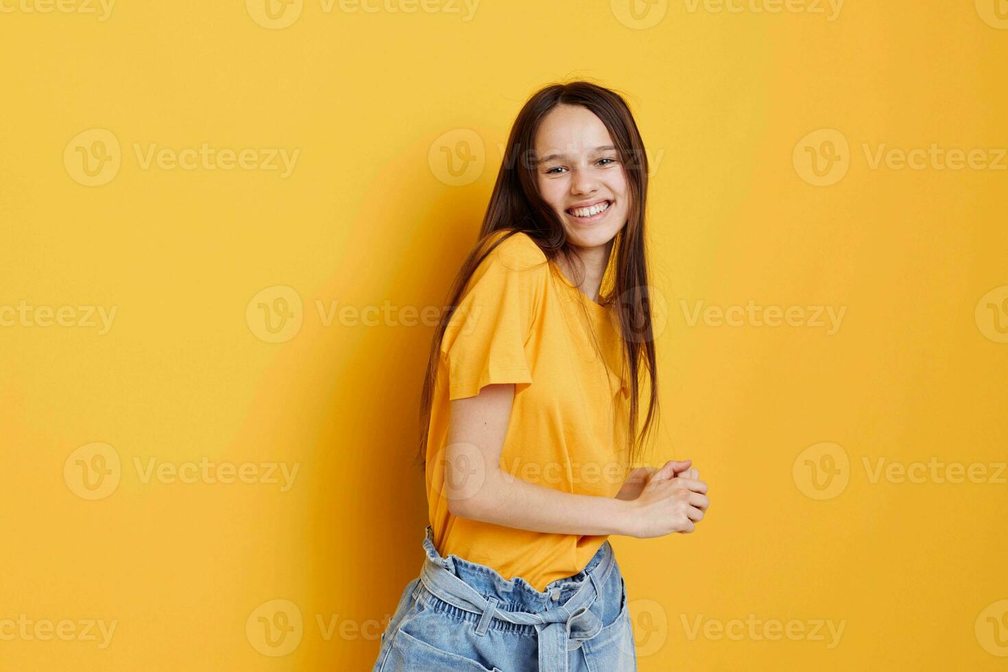 attractive woman in a yellow t-shirt emotions summer style yellow background photo