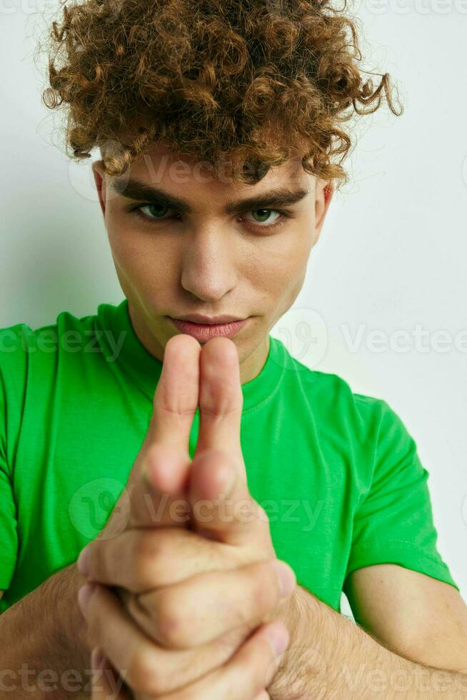 Attractive man in green t-shirts emotions posing isolated background photo