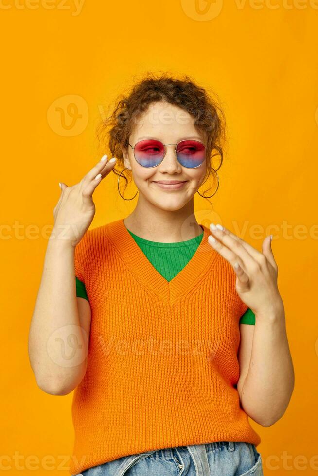 portrait of a young woman multicolored sunglasses on face posing grimace isolated backgrounds unaltered photo