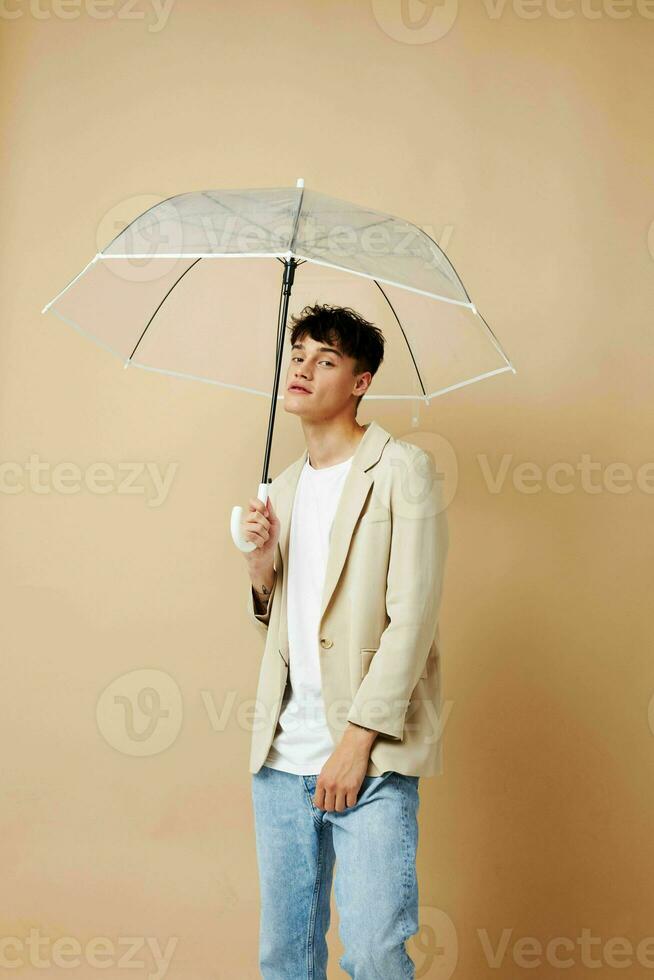 photo of a young guy in a white jacket with an open umbrella