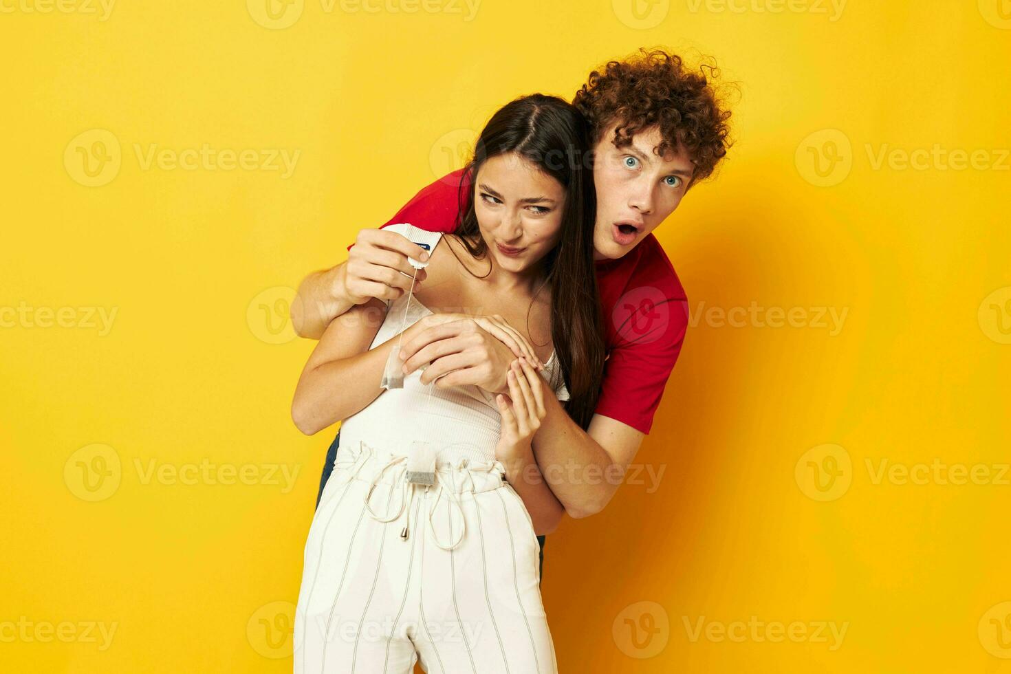 young couple together with a tea bag yellow background photo