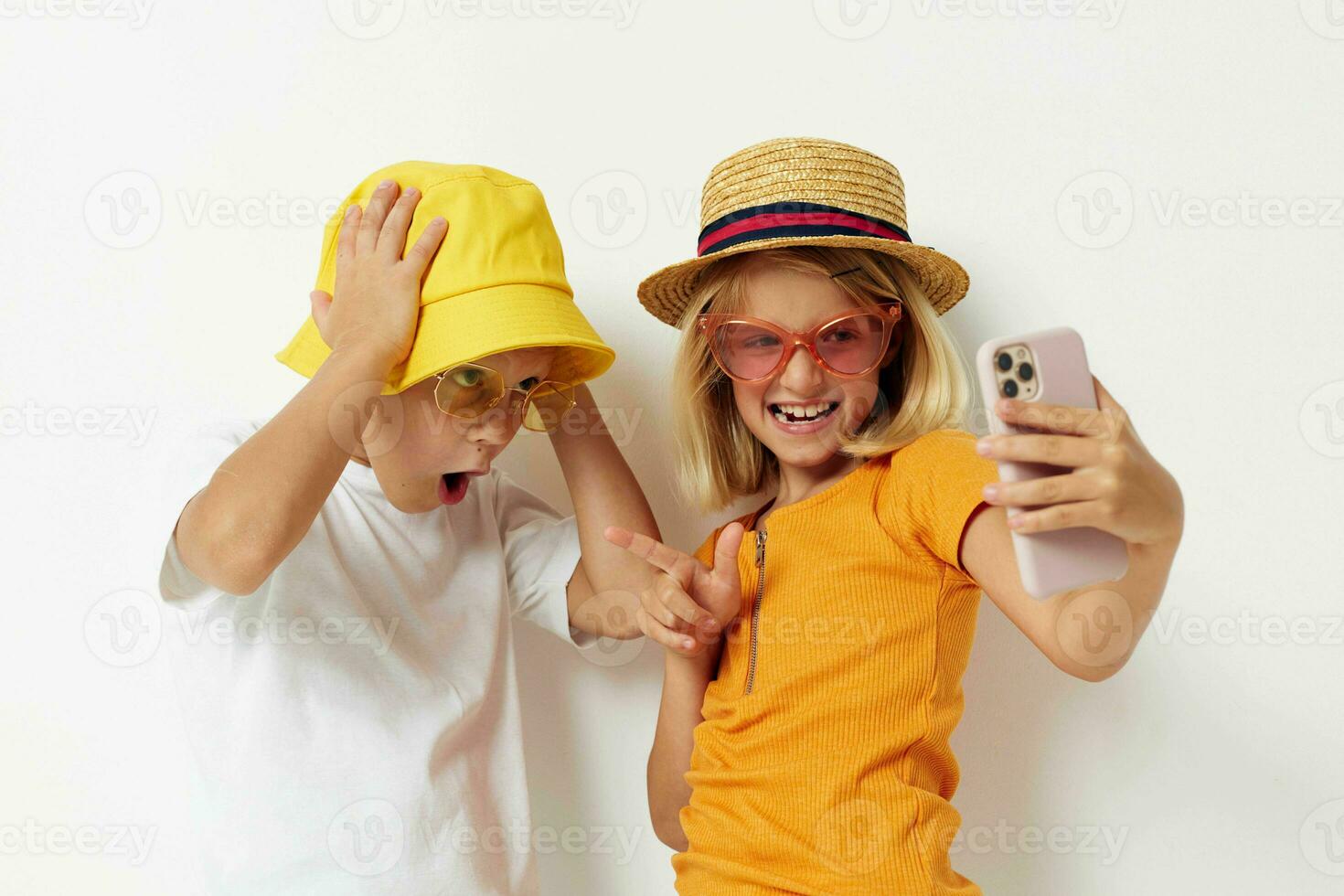 children in hats with phone together friendship photo
