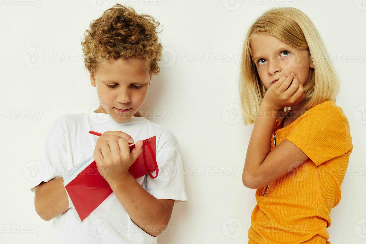 two joyful children draw in the notebook childhood entertainment color background unaltered photo
