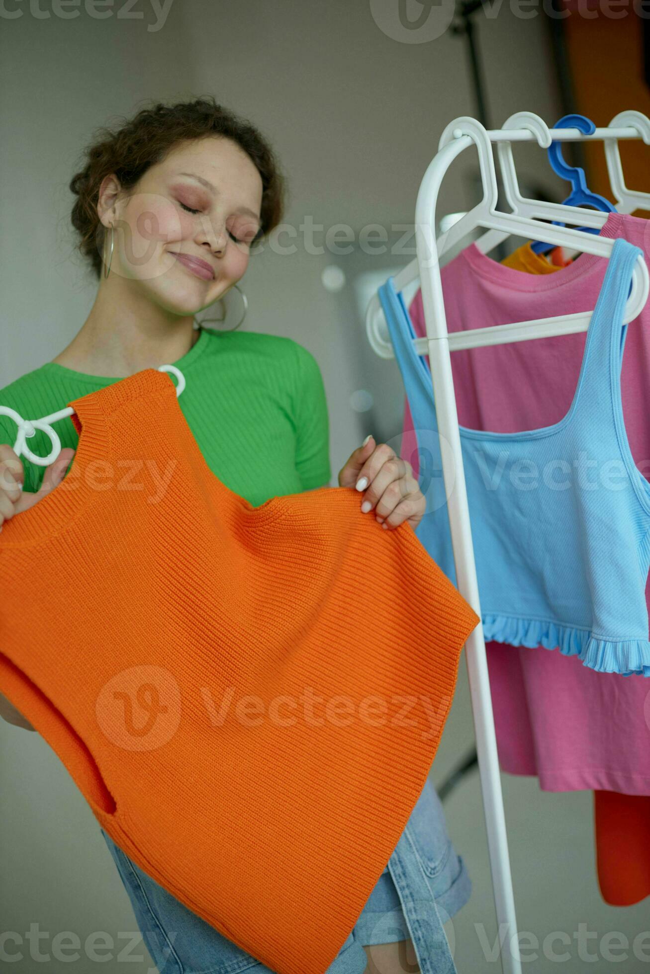 pretty girl trying on clothes wardrobe Youth style cropped view