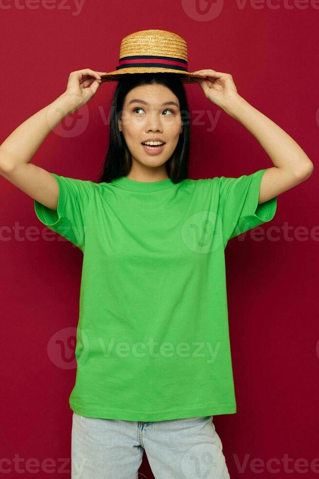 Charming young Asian woman in a green t-shirt gesturing with his hands fun studio model unaltered photo