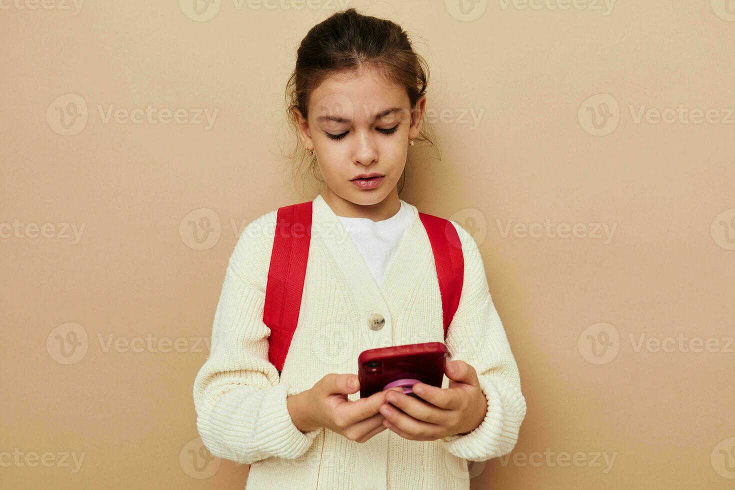 cute girl with phone posing red backpack Lifestyle unaltered photo