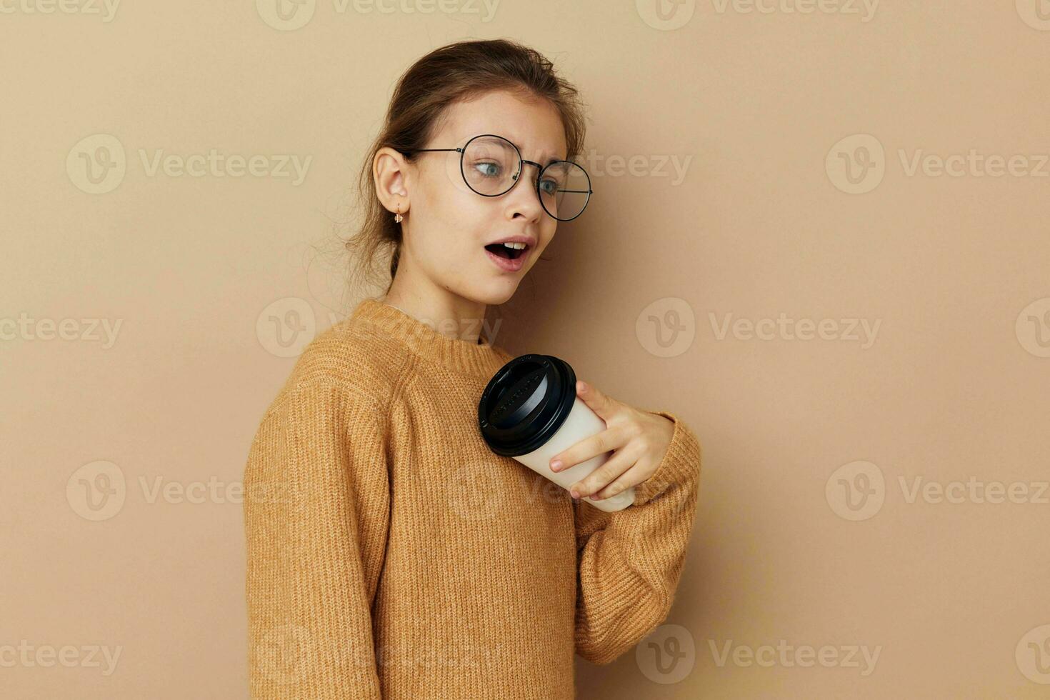 little girl wearing glasses posing glass with drink photo