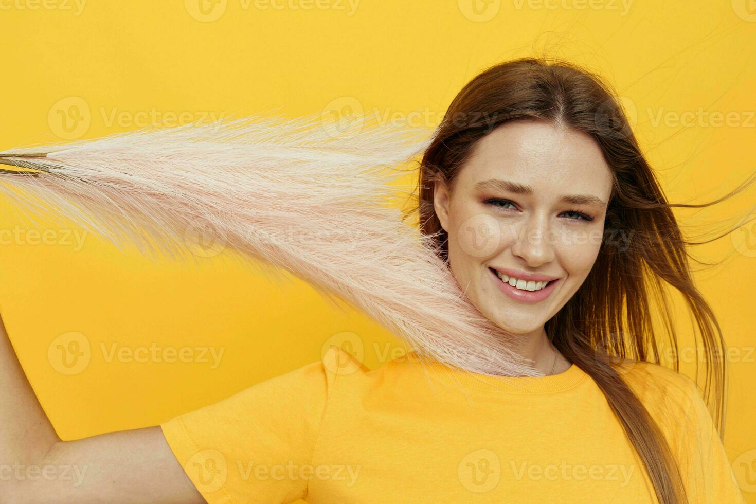 Young woman posing pink feathers in hands charm fashion yeah isolated background photo