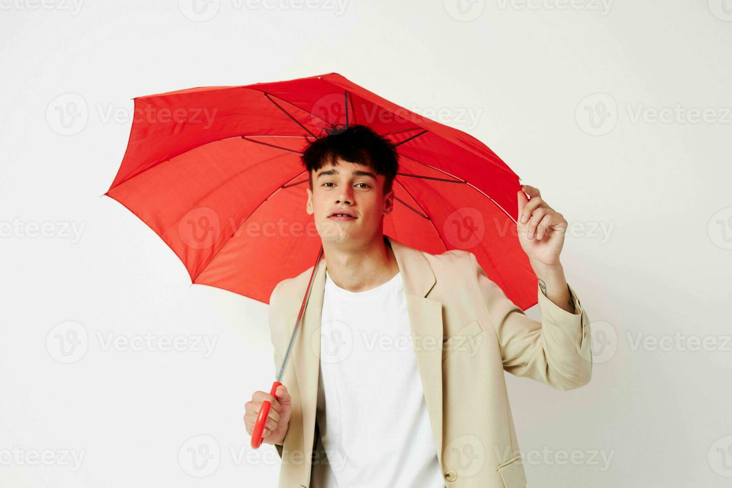 handsome guy red umbrella a man in a light jacket isolated background unaltered photo
