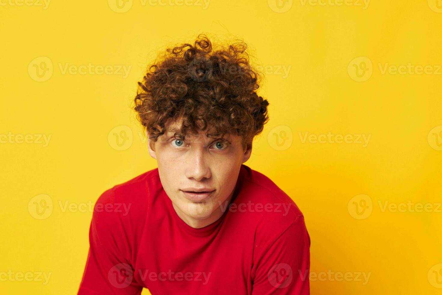 Young curly-haired man summer style fashion posing isolated background unaltered photo