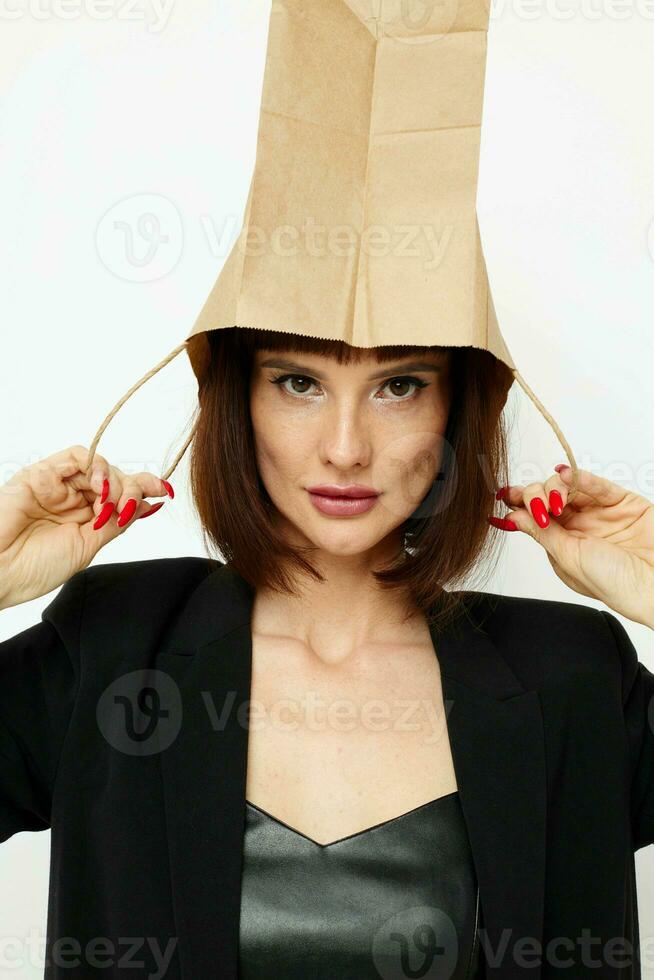 photo pretty woman in a black short-haired suit paper bag light background