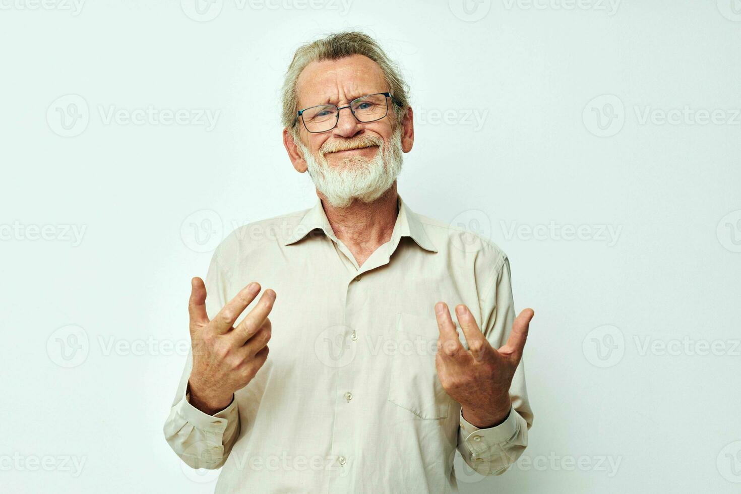 Portrait elderly man with a gray beard in a shirt and glasses light background photo