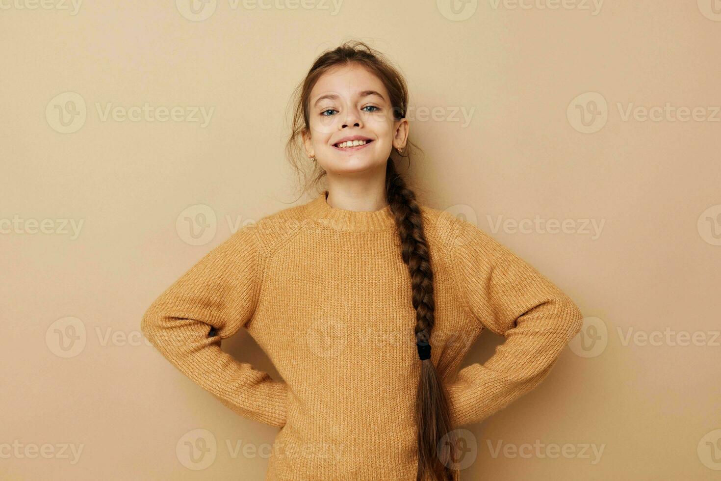 pretty young girl long pigtail beige sweater grimace Lifestyle unaltered photo