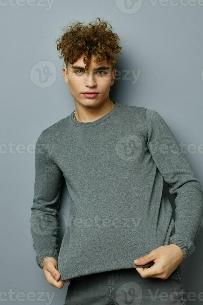 handsome guy in a gray sweatshirt fashion studio Lifestyle unaltered photo
