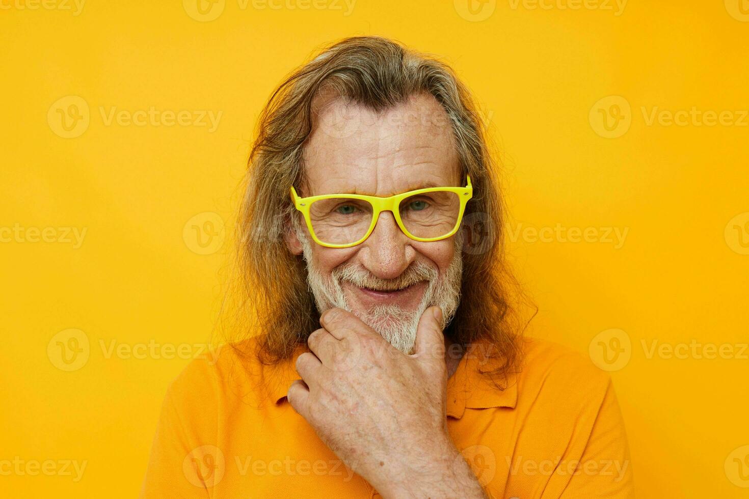 Photo of retired old man yellow t-shirt and glasses posing yellow background