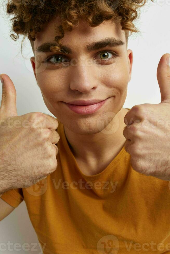 Attractive man in yellow t-shirts gesture hands emotions Lifestyle unaltered photo