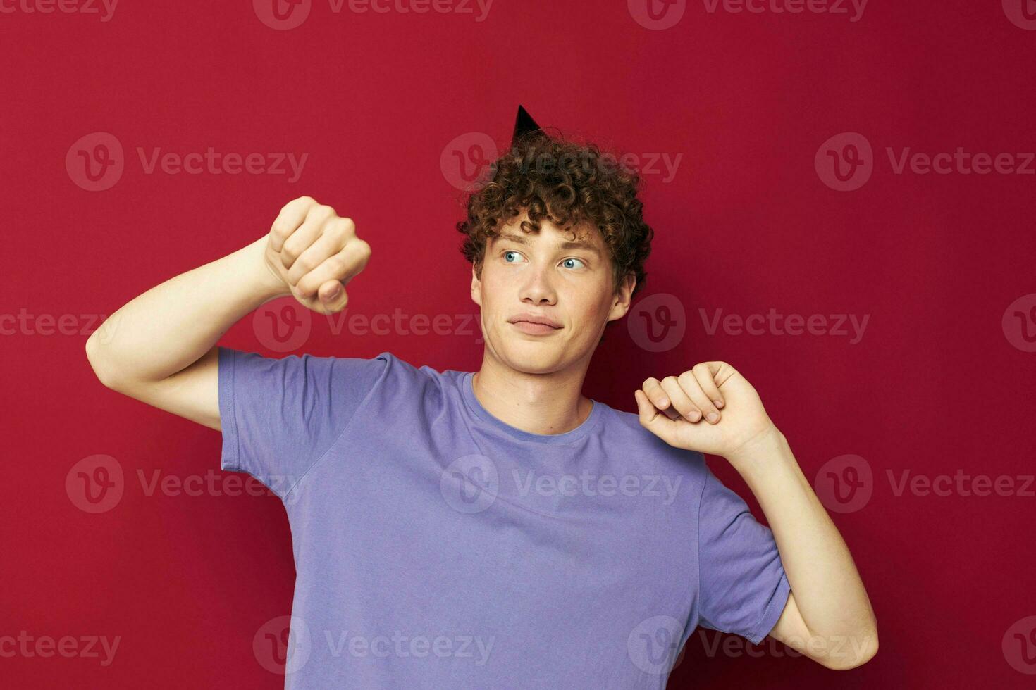 Cheerful guy with a cap on his head holiday red background photo