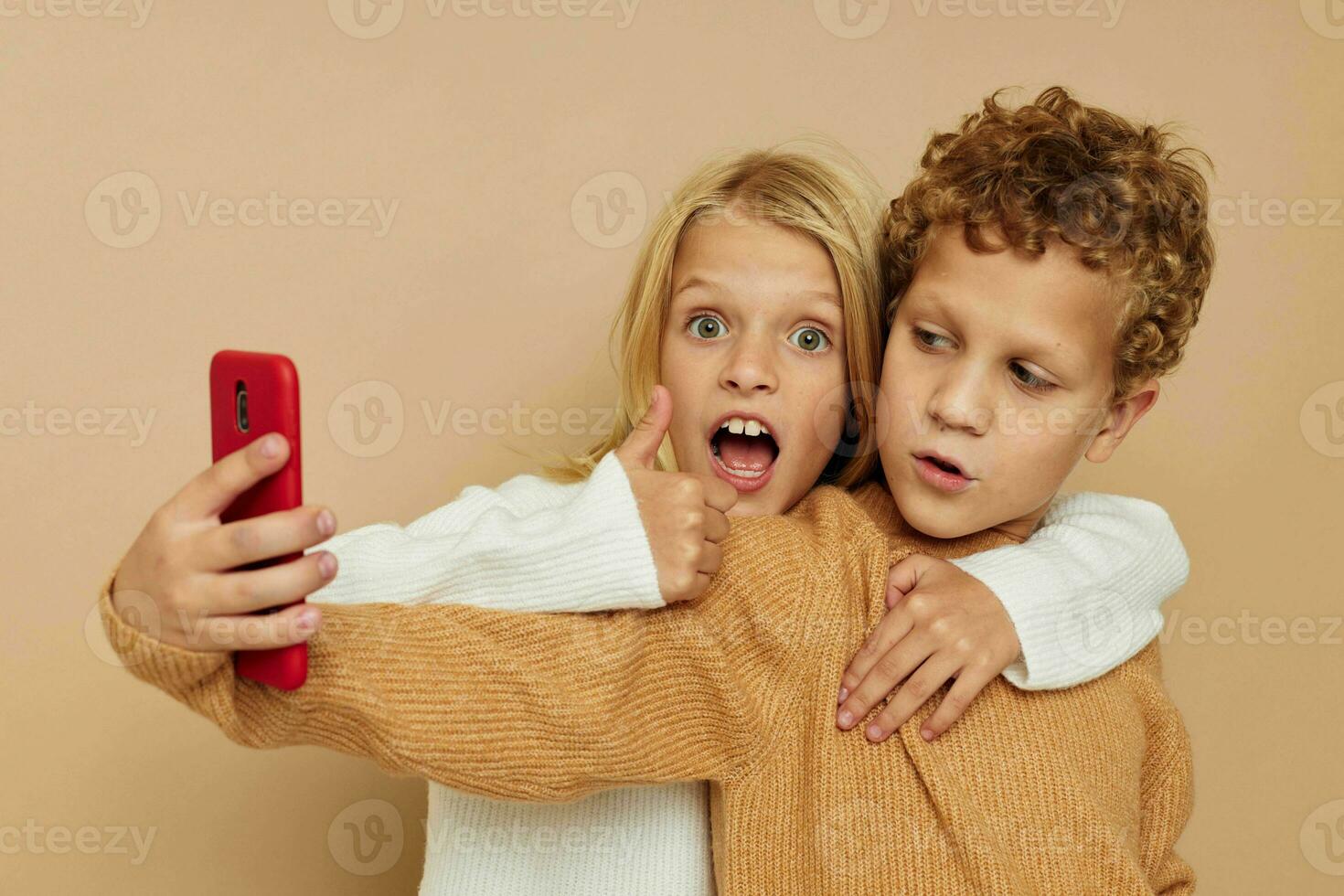 Portrait of cute children hug entertainment selfie posing friendship beige background photo