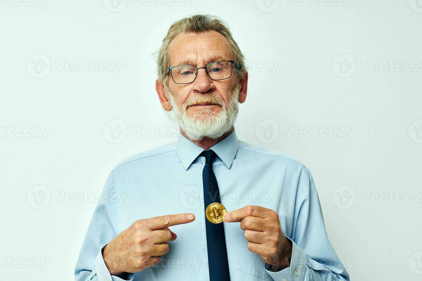 Portrait elderly man Bitcoin cryptocurrency in the hands of a financier isolated background photo