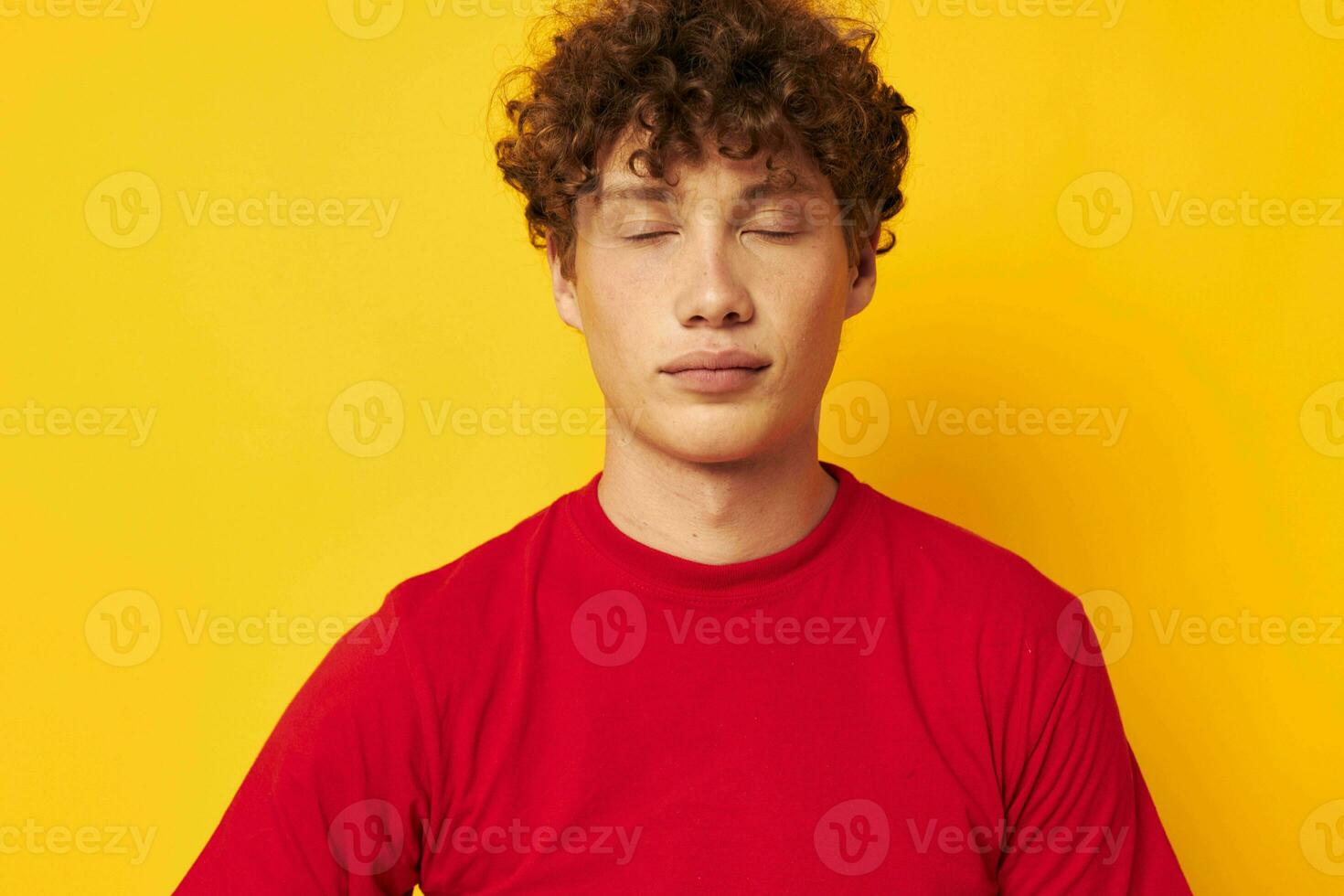 cute guy with curly hair in a red t-shirt close-up photo
