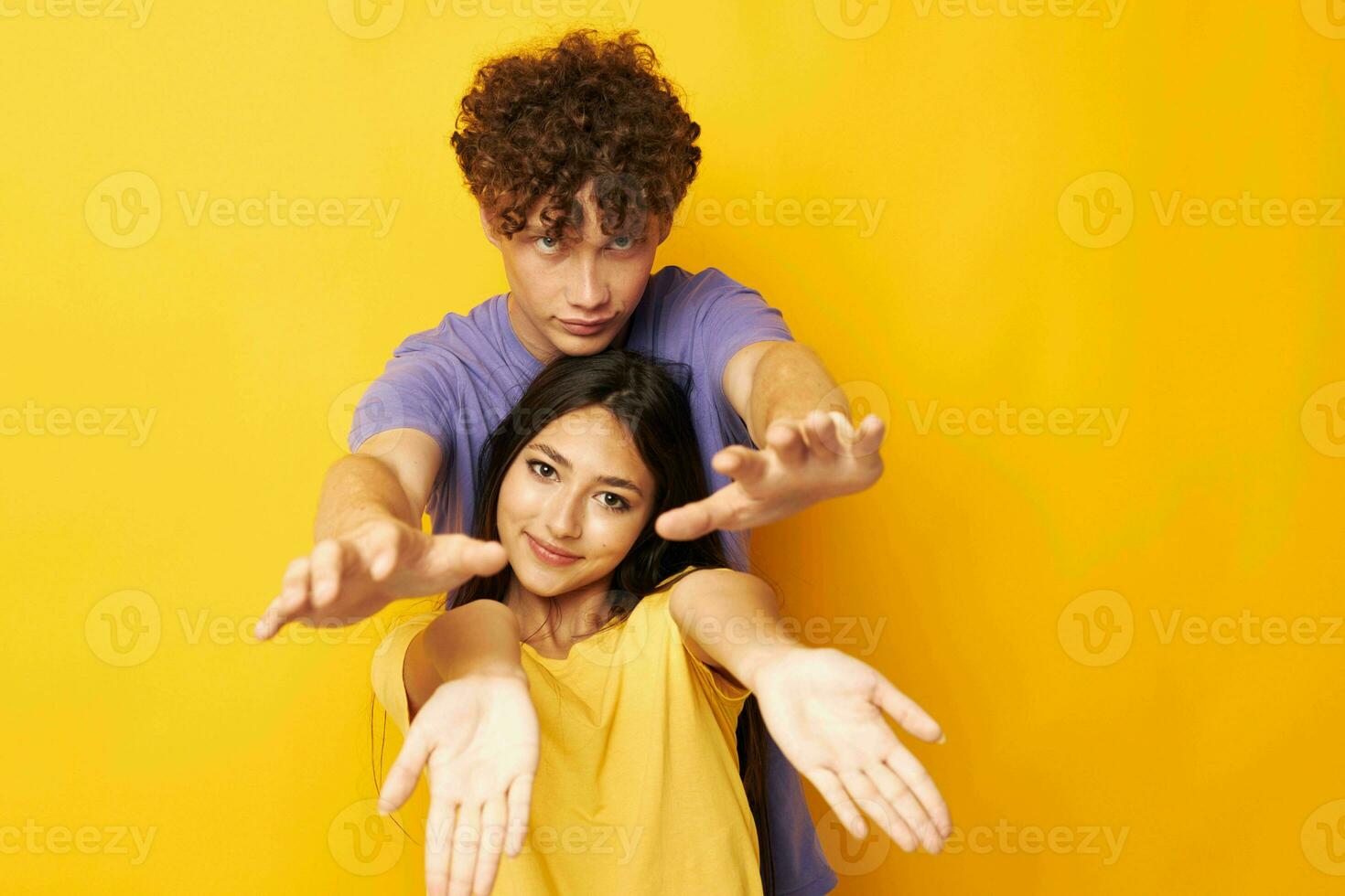 young boy and girl Friendship posing fun studio yellow background unaltered photo