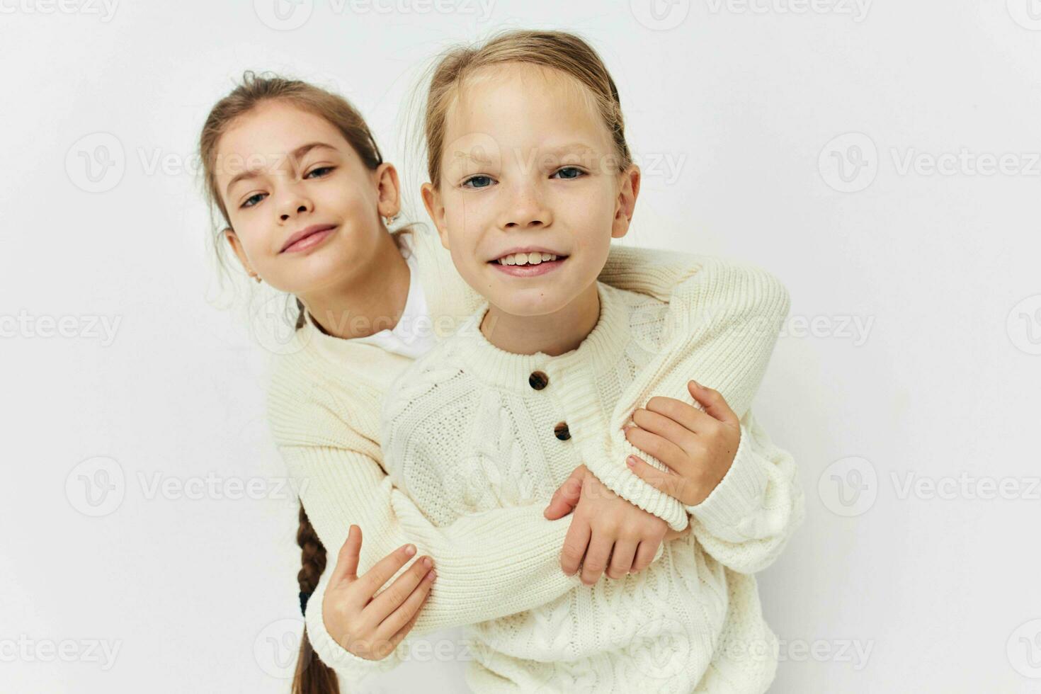 two friends are standing side by side fun childhood light background photo