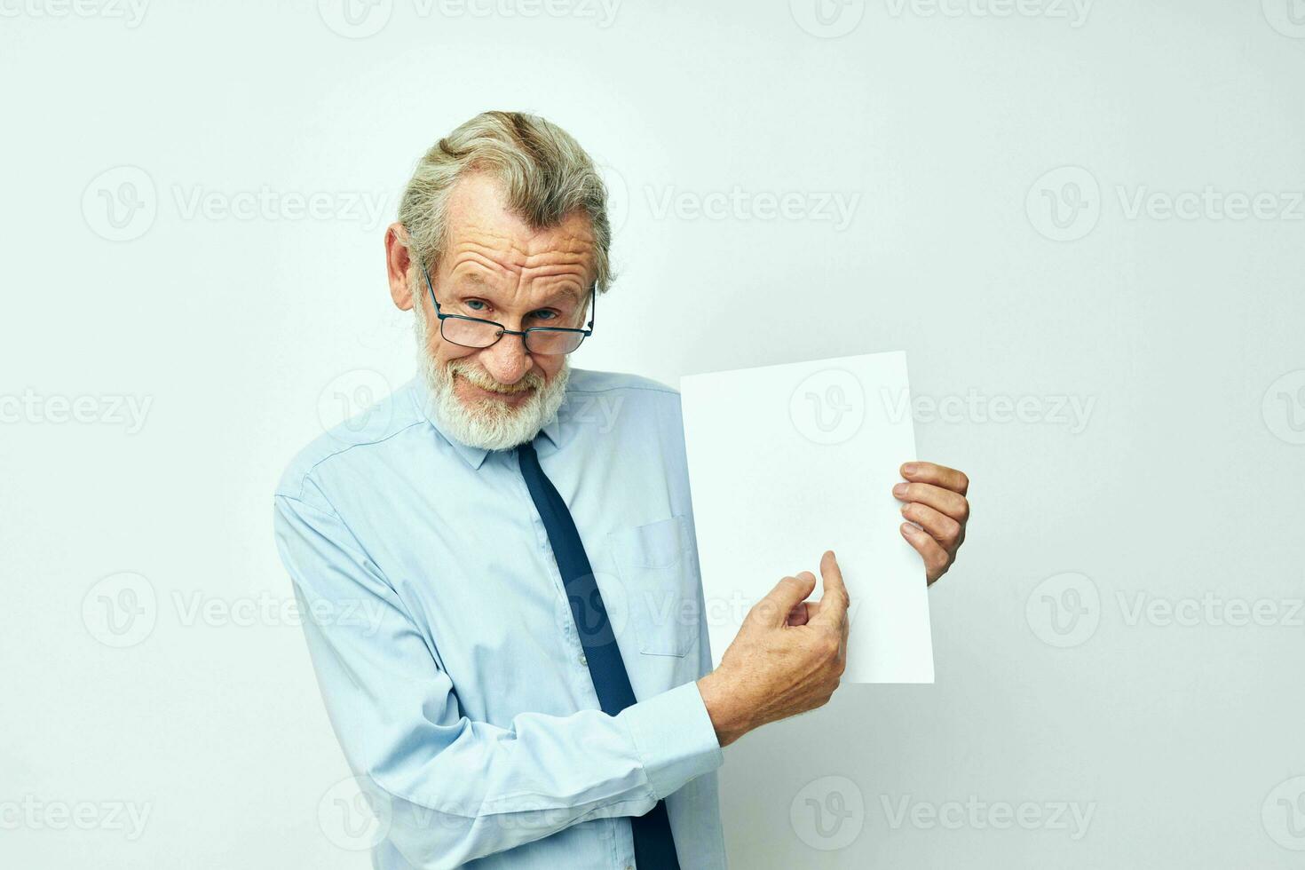 Portrait elderly man holding documents with a sheet of paper cropped view photo