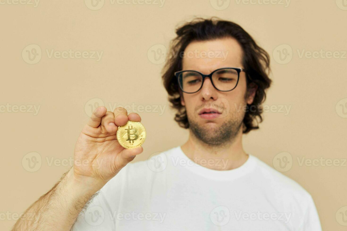 handsome man in a white T-shirt with Bitcoin cryptocurrency Lifestyle unaltered photo
