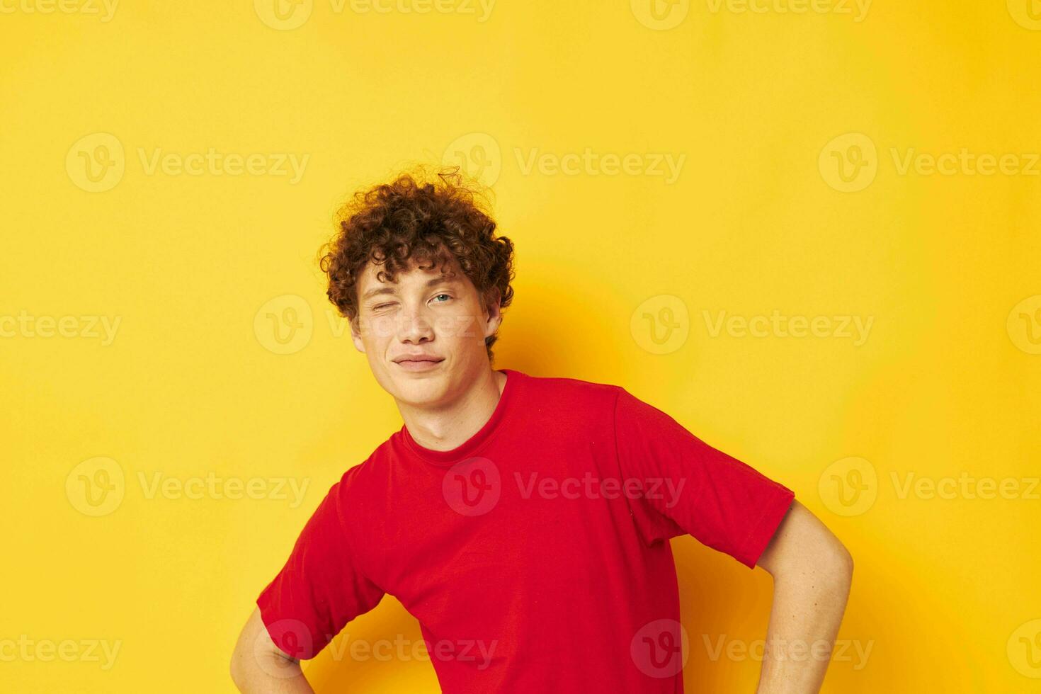 Young curly-haired man summer style fashion posing isolated background unaltered photo