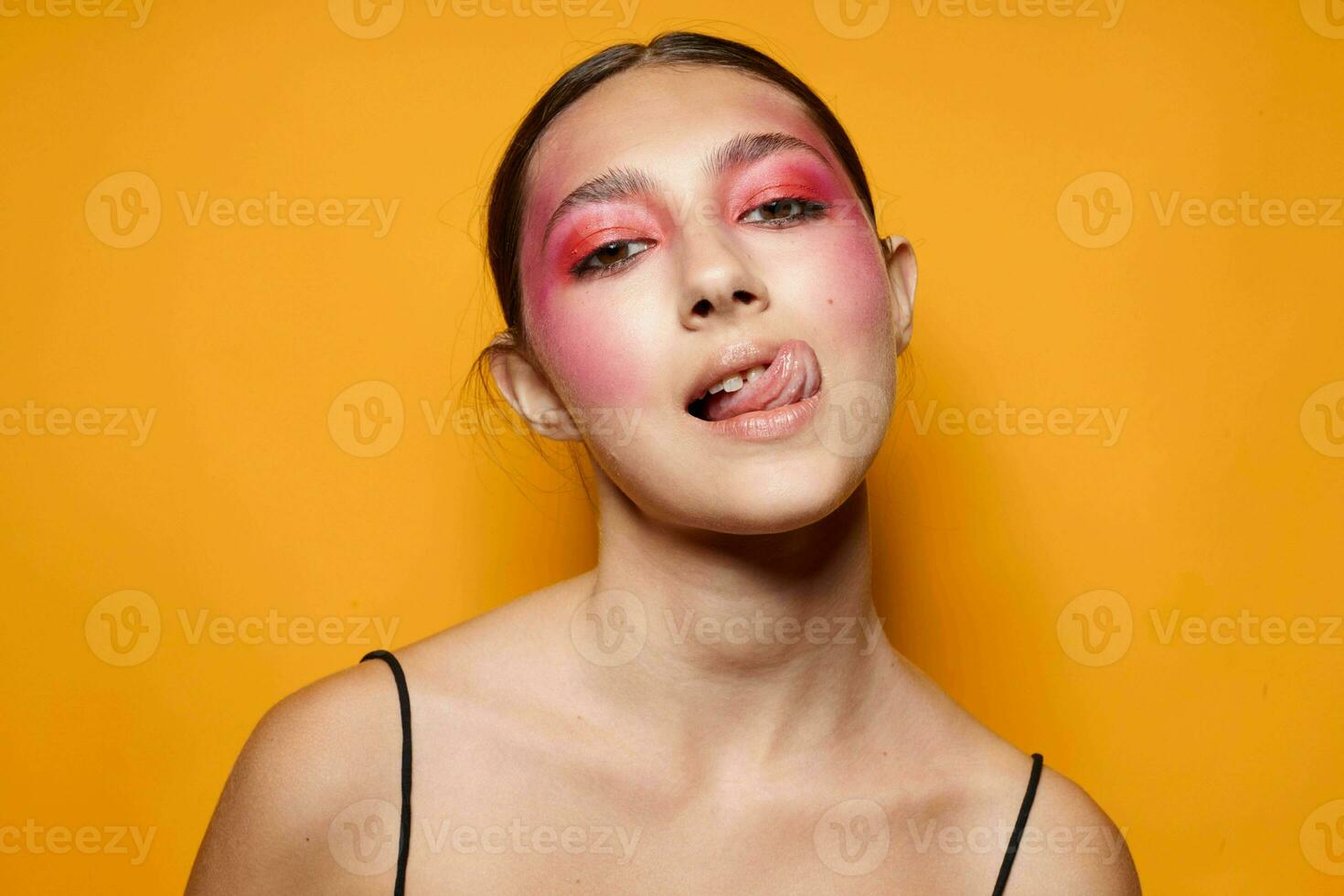 fashionable woman pink face makeup posing attractive look yellow background unaltered photo