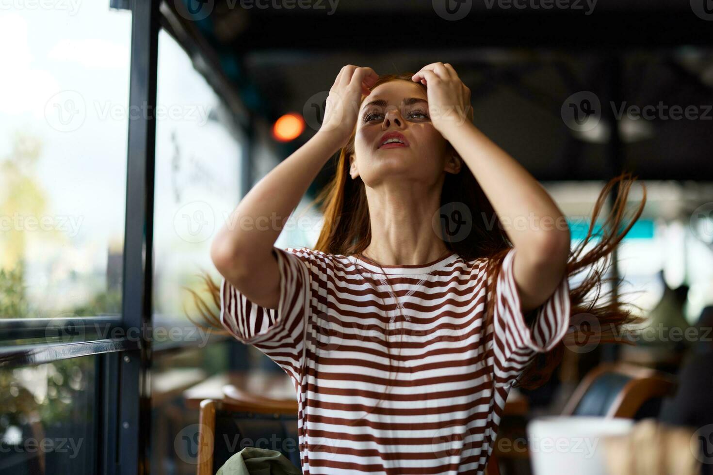 A beautiful woman sits in a cafe with a mug of coffee and smiling, lifestyle recreation photo