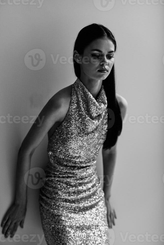Black and white portrait of a stylish woman in an evening dress with glitter eye makeup, disco style party photo