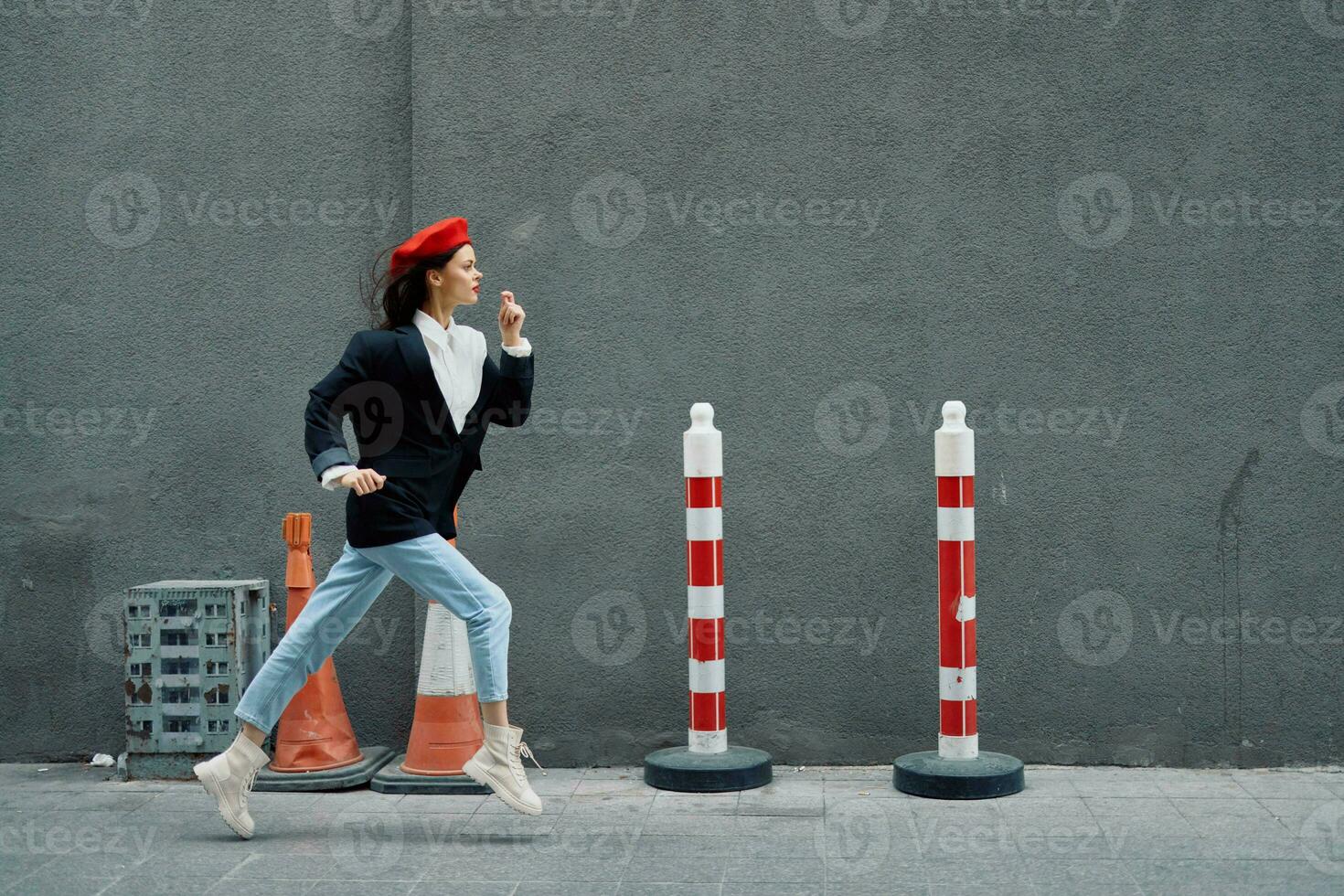 Fashion woman running down the street in front of the city tourist in stylish clothes with red lips and red beret, travel, cinematic color, retro vintage style, late to work. photo