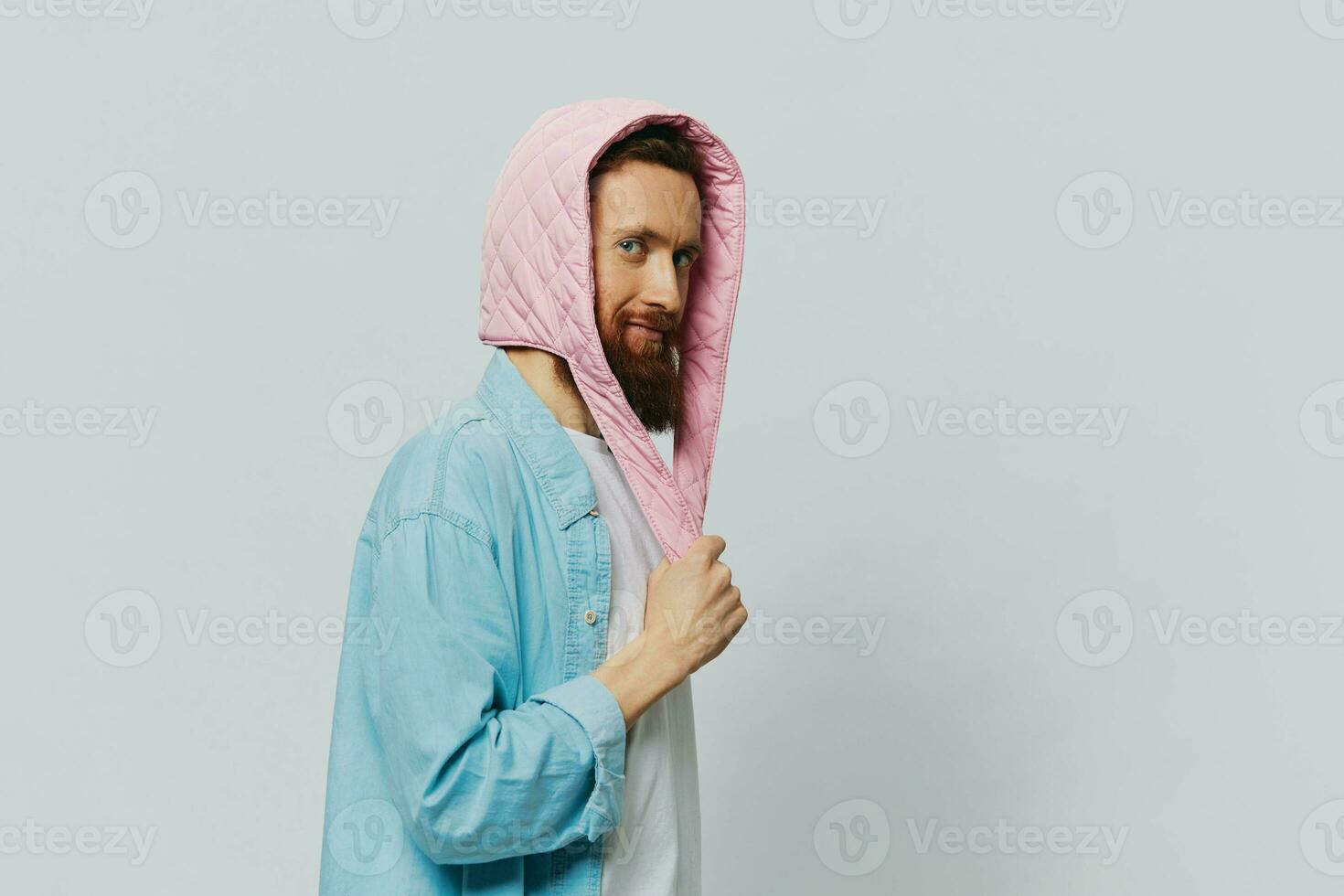 Funny man in a pink hat portrait on a light gray background. Smile and positive emotions. photo