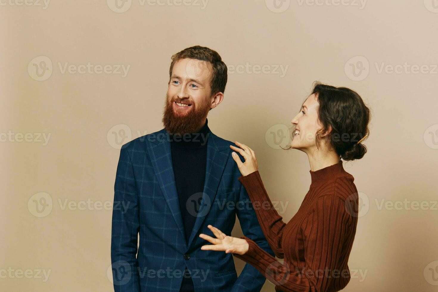 Man and woman couple in a relationship smile and interaction on a beige background in a real relationship between people photo