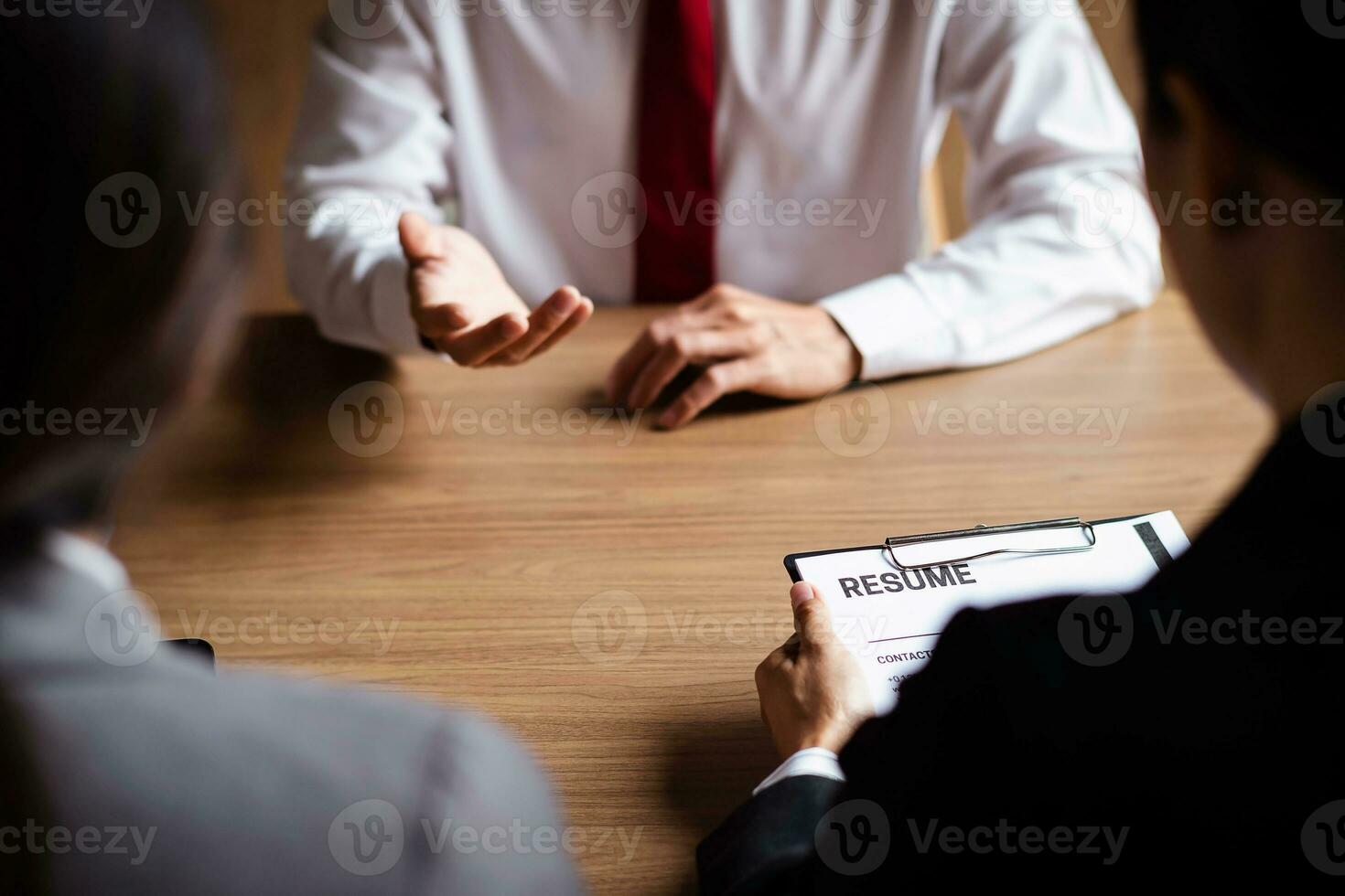 Image of employer or recruiter holding reading a resume during about colloquy his profile of candidate. photo