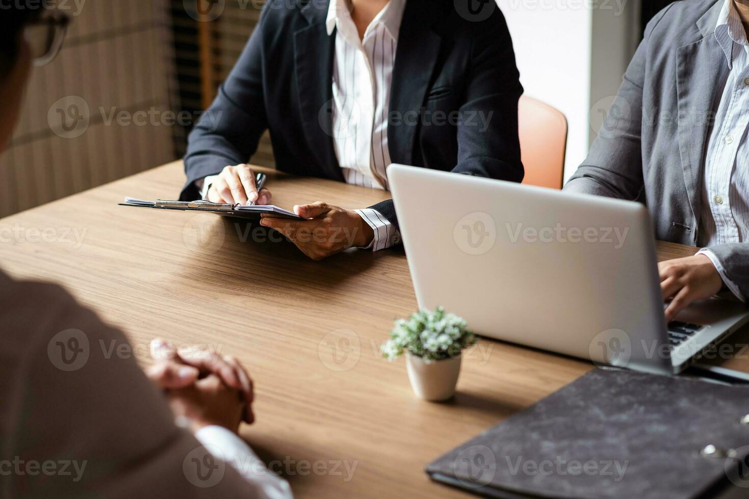 Image of employer or recruiter holding reading a resume during about colloquy his profile of candidate. photo